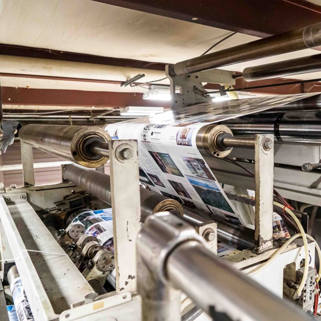 Large heat-set printing press printing multi-color pages.
