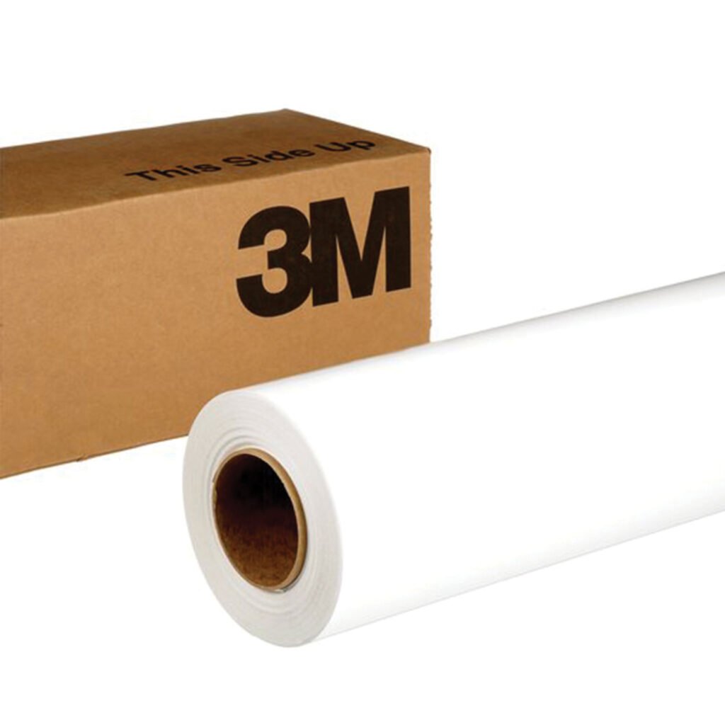 Brown box next to large roll of white vinyl.