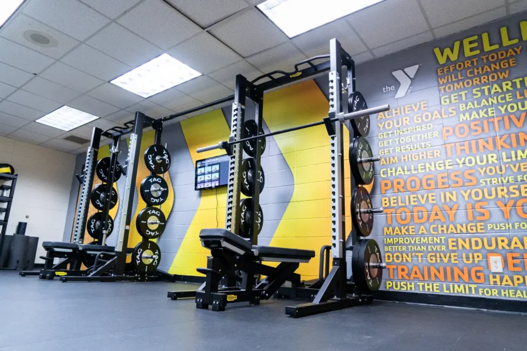 A gym with a bright yellow & gray wall decal.